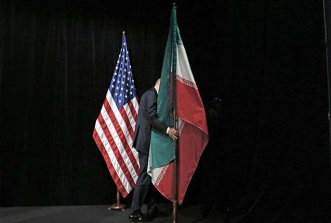 A staff member removes the Iranian flag from the stage after a group picture with foreign ministers and representatives of the Unites States, Iran, China, Russia, Britain, Germany, France, and the European Union during the Iran nuclear talks at the Vienna International Center in Vienna on July 14, 2015.