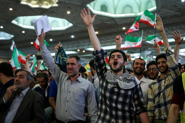 Supporters of Iranian presidential candidate Ebrahim Raisi chant slogans during a campaign meeting at the Mosalla mosque in Tehran, Iran, May 16, 2017.