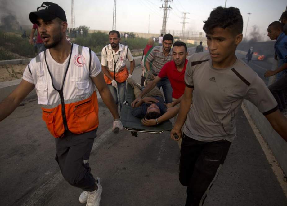 Palestinian medics evacuating wounded protester near the border between Gaza.jpg