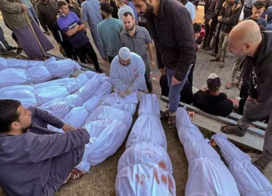 Palestinians check the bodies of people killed by Israeli airstrikes on the Jabalia refugee camp, at the Indonesian Hospital, northern Gaza Strip