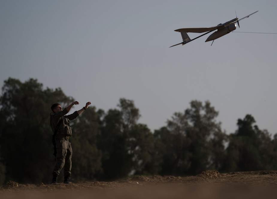 Israeli soldier launching drones