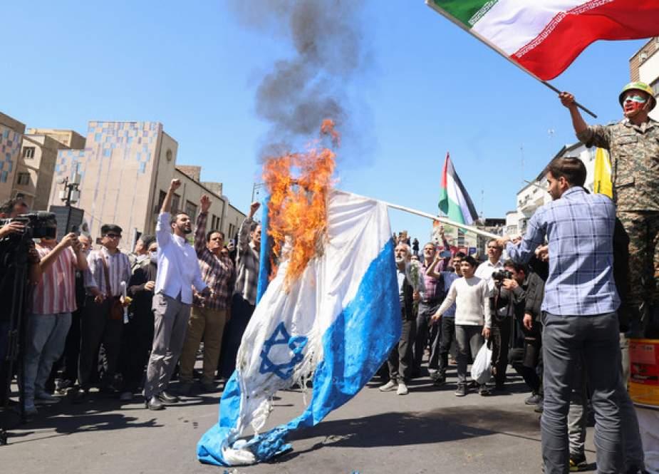 Demonstrators burn Israeli flags during the funeral of seven Revolutionary Guard Corps officers killed in a strike on Iran