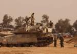 Israeli troops are seen near the border with the Gaza Strip