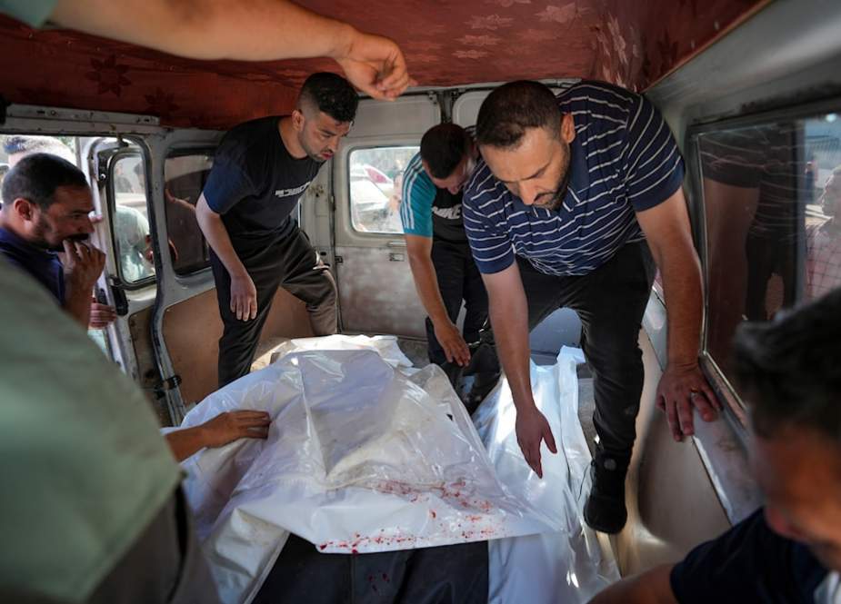 Palestinians bring people killed in the Israeli bombardment of the Gaza Strip to a hospital in Deir al Balah, the Gaza Strip