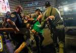 Israeli police disperse a protester against Israeli Prime Minister Benjamin Netanyahu
