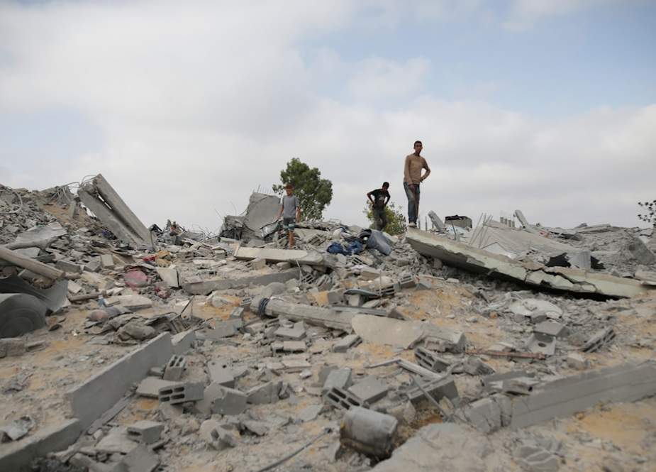 Palestinians look at the destruction after an Israeli airstrike in Khan Younis, Gaza Strip, occupied Palestine