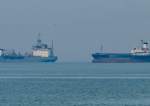 An Iranian oil tanker and cargo ship are shown in the Persian Gulf