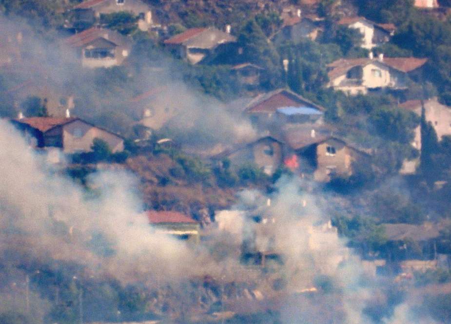 Hezbollah missiles burn buildings in Al-Metula