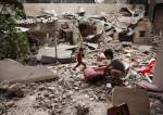 A Palestinian child salvages objects amid the debris of a house destroyed by overnight Israeli bombardment in Rafah, Gaza Strip