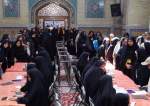 Dozens of women stand in line to cast their votes in Iran