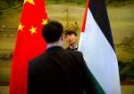Staff members check the alignment of Chinese, and Palestinian flags before the start of a joint press conference at the Ministry of foreign affairs in Beijing