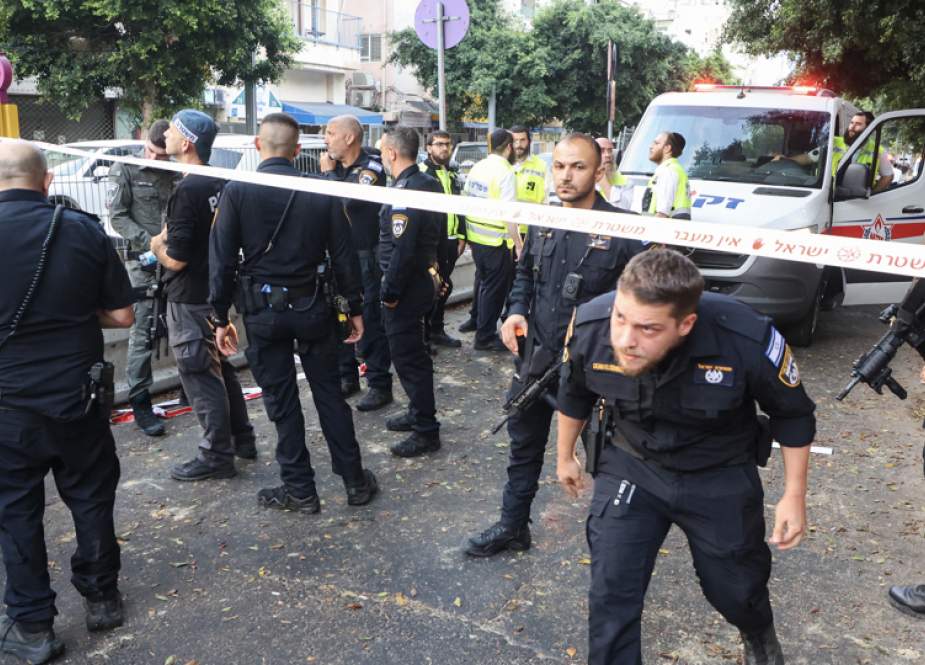 Israeli policemen search the scene of a Yemeni pro-Palestinian drone attack on Tel Aviv