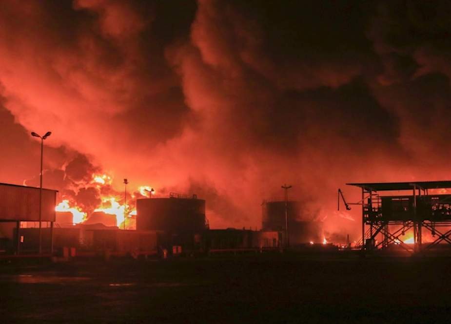 Oil tanks burn at the port in Hodeidah, Yemen, following an aggression by the Israeli occupation
